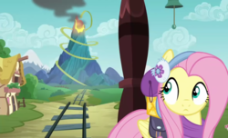 Size: 1775x1080 | Tagged: safe, screencap, fluttershy, pegasus, pony, dungeons and discords, g4, season 6, clothes, earmuffs, female, looking back, mare, ponyville, solo, train, train tracks, volcano