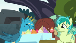 Size: 1280x720 | Tagged: safe, screencap, gallus, sandbar, yona, earth pony, griffon, pony, yak, g4, school daze, cupcake, cutie mark, eating, eyes closed, female, food, male, one eye closed, smiling, teenager, wings