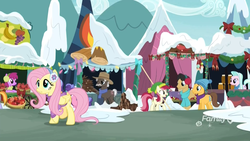 Size: 1920x1080 | Tagged: safe, screencap, auburn vision, berry blend, berry bliss, berry punch, berryshine, burnt oak, caramel, cherry cola, cherry fizzy, fluttershy, tender brush, winter lotus, earth pony, pegasus, pony, g4, my little pony best gift ever, apple, bow, christmas, christmas lights, clothes, decoration, discovery family logo, earmuffs, female, firewood, flower, fluttershy's purple sweater, food, friendship student, hat, holiday, male, mare, ponyville, rose, scarf, snow, stallion, sweater, sweatershy, tent, vendor, vendor stall, winter outfit