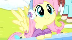 Size: 1920x1080 | Tagged: safe, screencap, fluttershy, pegasus, pony, g4, my little pony best gift ever, clothes, cute, earmuffs, female, fluttershy's purple sweater, mare, shyabetes, smiling, snow, solo focus, spread wings, sweater, sweatershy, wings, winter outfit
