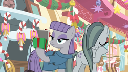 Size: 1920x1080 | Tagged: safe, screencap, marble pie, maud pie, earth pony, pony, g4, my little pony best gift ever, bell, bow, box, candy, candy cane, decoration, duo, female, fireplace, food, hearth's warming, hearth's warming ornament, hoof over mouth, laughing, mare, maud being maud, pinkie pie's room, present, rock-in-the-box, sisters, sugarcube corner