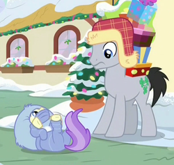Size: 915x868 | Tagged: safe, screencap, alula, lucky clover, pluto, earth pony, pony, g4, my little pony best gift ever, a christmas story, christmas, christmas lights, clothes, cropped, cute, duo, female, filly, foal, hat, holiday, male, on back, ponyville, present, snow, snowsuit, stallion, winter outfit