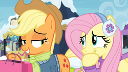 Size: 1920x1080 | Tagged: safe, screencap, applejack, fluttershy, earth pony, pegasus, pony, g4, my little pony best gift ever, applejack's hat, clothes, cowboy hat, cute, duo, earmuffs, eye contact, female, fluttershy's purple sweater, giggling, grin, hat, hoof over mouth, jacket, laughing, lidded eyes, looking at each other, mare, rainbow falls (location), scarf, shopping bag, shyabetes, smiling, snow, sweater, sweatershy, winter outfit