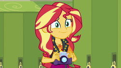 Size: 1920x1080 | Tagged: safe, screencap, sunset shimmer, equestria girls, equestria girls series, forgotten friendship, g4, camera, clothes, female, geode of empathy, jacket, leather jacket, magical geodes, smiling, solo