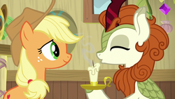 Size: 1280x720 | Tagged: safe, screencap, applejack, autumn blaze, kirin, g4, season 8, sounds of silence, applejack's hat, blowing, candle, cowboy hat, hat, out of context, shipping fuel, smiling