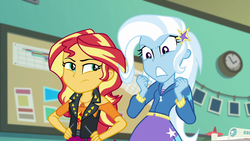 Size: 1920x1080 | Tagged: safe, screencap, sunset shimmer, trixie, equestria girls, equestria girls specials, g4, my little pony equestria girls: better together, my little pony equestria girls: forgotten friendship, angry, barrette, belt, clothes, cutie mark on clothes, dress, drone, exasperated face, female, geode of empathy, hairclip, hand on hip, hoodie, jacket, leather jacket, magical geodes, off shoulder, selfie drone, skirt, standing