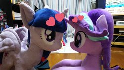 Size: 1200x675 | Tagged: safe, artist:nekokevin, starlight glimmer, trixie, twilight sparkle, alicorn, pony, unicorn, series:nekokevin's glimmy, g4, duo, female, heart, irl, looking at each other, mare, photo, plushie, sitting, smiling, television, twilight sparkle (alicorn)