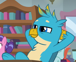 Size: 678x550 | Tagged: safe, screencap, gallus, griffon, pony, a rockhoof and a hard place, g4, arm behind back, arm behind head, background pony, bookshelf, chest fluff, cropped, cute, gallabetes, inkwell, male, offscreen character, paws, smiling, smirk, solo, wings