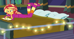Size: 1170x629 | Tagged: safe, screencap, sunset shimmer, equestria girls, equestria girls specials, g4, my little pony equestria girls: better together, my little pony equestria girls: forgotten friendship, ass, bed, bunset shimmer, butt, clothes, cropped, string lights, sunset's apartment, the pose, tongue out, writing