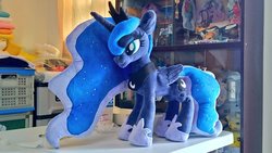 Size: 1024x577 | Tagged: safe, artist:nekokevin, princess luna, alicorn, pony, g4, female, hoof shoes, irl, mare, peytral, photo, plushie, regalia, smiling, solo, table