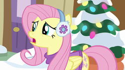 Size: 1280x720 | Tagged: safe, screencap, fluttershy, pegasus, pony, g4, my little pony best gift ever, clothes, earmuffs, female, fluttershy's purple sweater, mare, open mouth, snow, solo, sweater, sweatershy, winter outfit