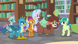 Size: 1280x720 | Tagged: safe, screencap, gallus, ocellus, sandbar, silverstream, smolder, yona, changedling, changeling, classical hippogriff, dragon, earth pony, griffon, hippogriff, pony, yak, g4, what lies beneath, bookshelf, bow, cloven hooves, colored hooves, cutie mark, dragoness, female, globe, hair bow, jewelry, library, male, monkey swings, necklace, student six, teenager