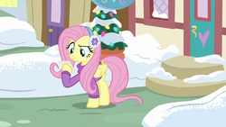 Size: 1280x720 | Tagged: safe, screencap, fluttershy, pegasus, pony, best gift ever, g4, clothes, earmuffs, female, fluttershy's purple sweater, mare, snow, solo, sweater, sweatershy, winter outfit