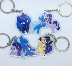 Size: 713x652 | Tagged: safe, daybreaker, nightmare moon, princess luna, starlight glimmer, trixie, alicorn, pony, unicorn, a royal problem, g4, road to friendship, to change a changeling, bow, cape, clothes, cute, hat, irl, keychain, photo, tongue out, trixie's cape, trixie's hat