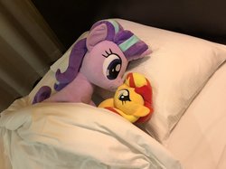 Size: 2048x1535 | Tagged: safe, artist:nekokevin, starlight glimmer, sunset shimmer, pony, unicorn, series:nekokevin's glimmy, g4, bed, bedsheets, boop, duo, female, irl, lying down, mare, noseboop, photo, pillow, plushie, size difference, smiling