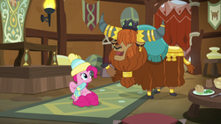 Size: 1280x720 | Tagged: safe, screencap, pinkie pie, prince rutherford, earth pony, pony, yak, g4, my little pony best gift ever, clothes, cloven hooves, crown, duo, ear piercing, earring, female, hair over eyes, hat, horn, horn ring, house, jewelry, male, mare, open mouth, piercing, raised hoof, regalia, scarf, toque, winter outfit