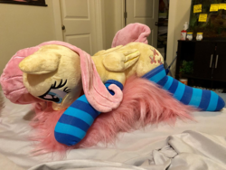 Size: 1422x1067 | Tagged: safe, artist:dawning love, artist:natureshy, fluttershy, pony, g4, clothes, head down, heart eyes, irl, lying down, photo, plushie, socks, solo, striped socks, wingding eyes