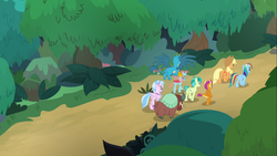 Size: 1366x768 | Tagged: safe, screencap, applejack, gallus, ocellus, rainbow dash, sandbar, silverstream, smolder, yona, changedling, changeling, classical hippogriff, dragon, earth pony, griffon, hippogriff, pegasus, pony, yak, g4, non-compete clause, bow, butt, cloven hooves, colored hooves, cowboy hat, dragoness, female, flying, forest, hair bow, hat, jewelry, male, mare, monkey swings, necklace, plot, spread wings, student six, teenager, tree, walking, wings