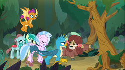 Size: 1366x768 | Tagged: safe, screencap, gallus, ocellus, sandbar, silverstream, smolder, yona, changedling, changeling, classical hippogriff, dragon, earth pony, griffon, hippogriff, pony, yak, g4, non-compete clause, bow, cloven hooves, colored hooves, dragoness, female, flying, forest, gesture, hair bow, jewelry, male, monkey swings, necklace, raised hoof, student six, teenager, tree