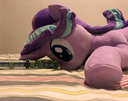 Size: 1004x790 | Tagged: safe, artist:nekokevin, starlight glimmer, pony, unicorn, series:nekokevin's glimmy, g4, bed, female, irl, looking at something, mare, micro, object, photo, plushie, size difference, smiling, solo, train, underhoof