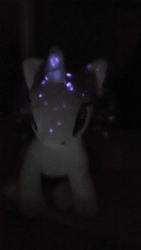 Size: 1920x1080 | Tagged: safe, rarity, g4, glowing, glowstick, irl, lowres, neon, photo, plushie, radioactive, toy, tritium