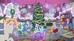 Size: 1280x720 | Tagged: safe, screencap, gallus, ocellus, rarity, sandbar, silverstream, smolder, yona, changedling, changeling, dragon, earth pony, griffon, hippogriff, pony, unicorn, yak, g4, hearth's warming shorts, my little pony best gift ever, mystery voice, bauble, chair, chalkboard, christmas, christmas ornament, christmas tree, christmas wreath, decoration, dragoness, fabric, female, hearth's warming doll, hearth's warming tree, holiday, magic, male, mare, ponyquin, present, rarity plushie, school of friendship, student six, teenager, telekinesis, tree, wreath