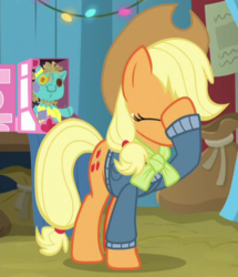 Size: 396x460 | Tagged: safe, screencap, applejack, holly the hearths warmer doll, earth pony, pony, g4, my little pony best gift ever, cropped, eyes closed, facehoof, female, mare, raised hoof, solo