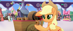 Size: 1920x804 | Tagged: safe, screencap, applejack, g4, my little pony: the movie, applejack's hat, balloon, bow, cake, cart, cider, confused, cotton candy, cowboy hat, flag, food, hat, hoof hold, jug, mug, ribbon, serious, tankard