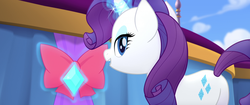 Size: 1920x804 | Tagged: safe, screencap, rarity, pony, g4, my little pony: the movie, bow, butt, female, gem, glowing horn, horn, lidded eyes, magic, magic aura, mare, plot, ribbon, smiling, solo