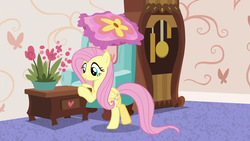 Size: 1280x720 | Tagged: safe, screencap, fluttershy, pegasus, pony, discordant harmony, g4, bipedal, bipedal leaning, chair, clock, couch, cute, female, flower, grandfather clock, leaning, mare, pot, pushing, shyabetes, smiling, solo, table