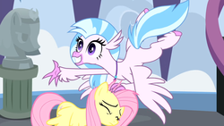Size: 1920x1080 | Tagged: safe, screencap, fluttershy, silverstream, classical hippogriff, hippogriff, pegasus, pony, g4, school daze, season 8, colored hooves, duo, female, grin, jewelry, mare, necklace, outstretched arm, smiling