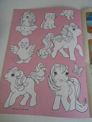Size: 720x960 | Tagged: safe, photographer:sweetbubbles, butterfly, cat, dog, duck, earth pony, pony, sea pony, g1, baby, baby pony, comic free gift, irl, magic drawing card, merchandise, photo, unknown pony
