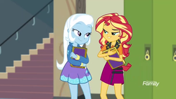 Size: 1280x720 | Tagged: safe, screencap, sunset shimmer, trixie, equestria girls, equestria girls specials, g4, my little pony equestria girls: better together, my little pony equestria girls: forgotten friendship, book, discovery family logo, duo, female, looking at each other