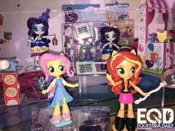 Size: 1210x907 | Tagged: safe, screencap, fluttershy, rarity, sunset shimmer, equestria girls, g4, my little pony equestria girls: better together, clothes, doll, dress, equestria girls logo, equestria girls minis, female, irl, jacket, photo, sandals, shoes, skirt, toy, toy fair, toy fair 2018