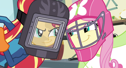 Size: 1489x812 | Tagged: safe, screencap, fluttershy, sunset shimmer, human, equestria girls, g4, my little pony equestria girls: friendship games, clothes, cropped, female, gloves, hockey mask, looking at each other, looking at someone, mask, posing for photo, right there in front of me, triangle, welding mask