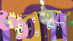 Size: 1280x720 | Tagged: safe, screencap, discord, fluttershy, pony, discordant harmony, g4, butterfly net, butterfly sandwich, ginseng teabags, upside down