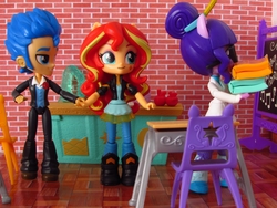 Size: 1520x1140 | Tagged: safe, artist:whatthehell!?, flash sentry, sci-twi, sunset shimmer, twilight sparkle, equestria girls, g4, apple, book, boots, chair, chalkboard, classroom, clothes, desk, doll, equestria girls minis, eqventures of the minis, female, food, guitar, holding hands, irl, jacket, lab coat, male, pair, pants, photo, school, ship:flashimmer, shipping, shoes, straight, toy, tuxedo