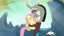 Size: 1280x720 | Tagged: safe, screencap, discord, fluttershy, draconequus, pegasus, pony, g4, to where and back again, cute, discute, duo, duo male and female, eyes closed, female, heartwarming, hug, male, mare, one eye closed, shipping fuel, shyabetes, smiling, sweet dreams fuel, when he smiles