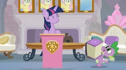 Size: 1654x927 | Tagged: safe, screencap, fluttershy, spike, twilight sparkle, alicorn, pony, g4, non-compete clause, book, couch, fireplace, twilight sparkle (alicorn), wall of shy