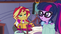 Size: 1280x720 | Tagged: safe, screencap, sci-twi, sunset shimmer, twilight sparkle, equestria girls, g4, my little pony equestria girls: legend of everfree, bag, bed, blushing, camp everfree outfits, clothes, duo, duo female, female, out of context, shirt, smugset shimmer, sweatshirt