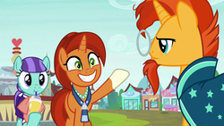 Size: 1280x720 | Tagged: safe, screencap, mixed berry, stellar flare, sunburst, earth pony, pony, unicorn, g4, the parent map, background pony, clothes, cup, female, glasses, grin, jewelry, male, mare, mother and son, necklace, raised hoof, robe, sire's hollow, smiling, stallion, sunburst is not amused, unamused