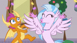 Size: 800x450 | Tagged: safe, screencap, silverstream, smolder, g4, the hearth's warming club, animated, christmas, christmas lights, female, hearth's warming, holiday, tuesday, wreath