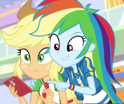 Size: 765x642 | Tagged: safe, screencap, applejack, rainbow dash, equestria girls, equestria girls specials, g4, my little pony equestria girls: better together, my little pony equestria girls: rollercoaster of friendship, cellphone, cropped, female, geode of super speed, geode of super strength, lip bite, magical geodes, phone, pointing, smartphone