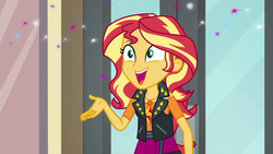 Size: 1280x720 | Tagged: safe, screencap, sunset shimmer, equestria girls, g4, my little pony equestria girls: better together, so much more to me, clothes, cute, cutie mark on clothes, female, geode of empathy, jewelry, leather, leather vest, magical geodes, necklace, open mouth, open smile, shoulderless shirt, skirt, smiling, solo, sparkles, spikes, talking, vest