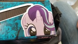 Size: 2048x1152 | Tagged: safe, starlight glimmer, trixie, pony, unicorn, g4, irl, merchandise, peeking, photo, rocket, soon, trixie's rocket