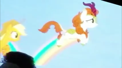 Size: 1280x720 | Tagged: safe, screencap, applejack, autumn blaze, kirin, pony, g4, season 8, sounds of silence, female, leaping, mare, photo, picture of a screen, rainbow, san diego comic con, sdcc 2018