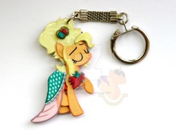 Size: 1024x778 | Tagged: safe, artist:king-franchesco, applejack, earth pony, pony, g4, simple ways, clothes, commission, dress, eyes closed, female, hooves, irl, keychain, mare, photo, raised hoof, smiling, solo