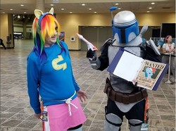Size: 602x447 | Tagged: safe, rainbow dash, bronycon, bronycon 2018, g4, clothes, cosplay, costume, crossdressing, female, irl, jango fatass, jango fett, male, male to female, one piece, photo, rule 63, shirt, skirt, star wars, sweater, wanted poster