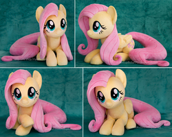 Size: 1826x1458 | Tagged: safe, artist:buttercupbabyppg, fluttershy, pegasus, pony, g4, cute, daaaaaaaaaaaw, female, folded wings, happy, hnnng, irl, looking up, lying, mare, photo, plushie, shyabetes, smiling, solo, weapons-grade cute