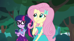 Size: 1280x720 | Tagged: safe, screencap, fluttershy, sci-twi, twilight sparkle, equestria girls, equestria girls series, g4, text support, female, geode of fauna, geode of telekinesis, glasses, hairpin, phone, ponytail, smiling, text support: fluttershy